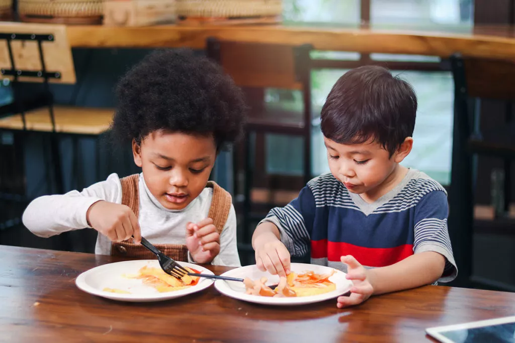 2 boys enjoying a snack together at a Rockville daycare.