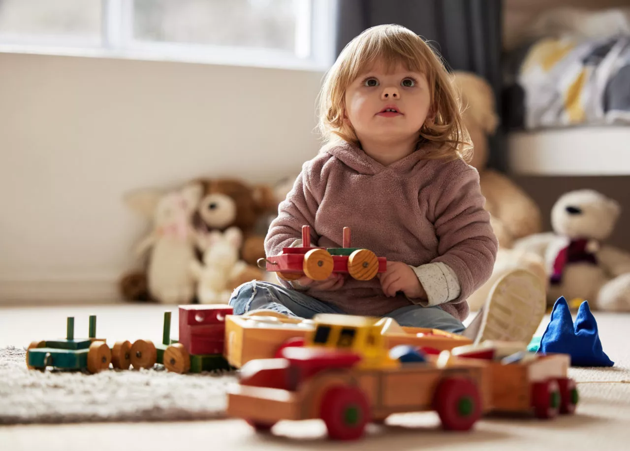 How to encourage independent play: Baby, toys and play in bedroom for development or learning, child in home for motor skills. Young kid, house and relax game with wood cars for education or creativity, wellness or cognitive growth.