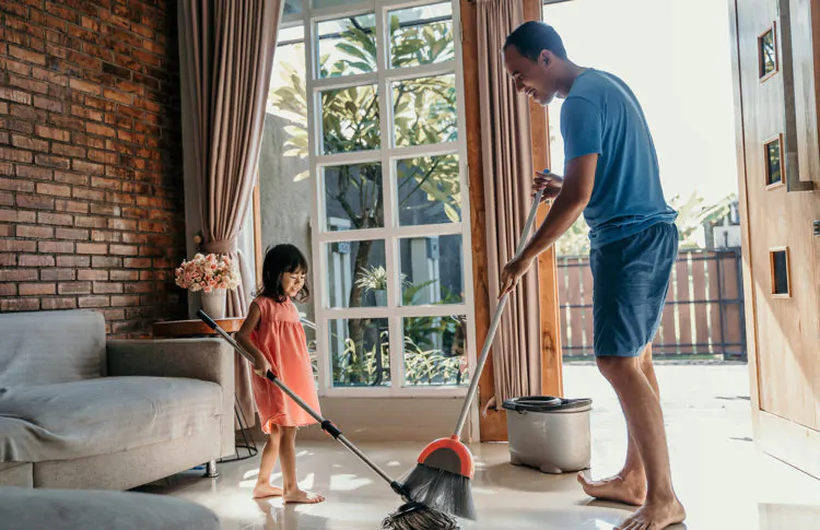 father and daughter clean up the house
