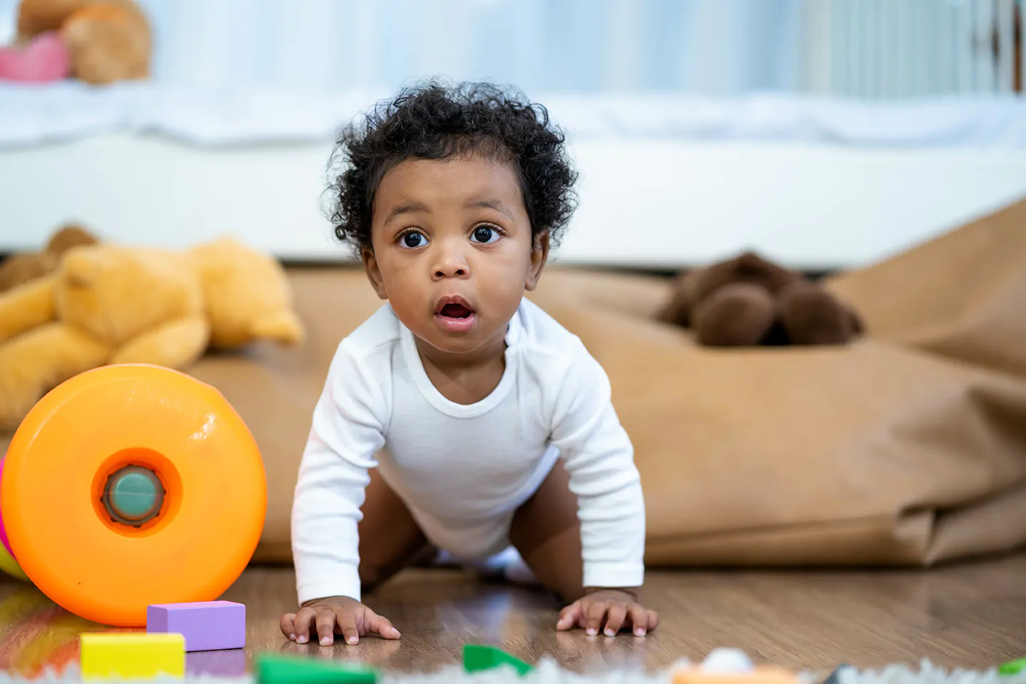 Curious infant at a Rockville daycare center exploring colorful toys, enhancing cognitive and tactile skills.