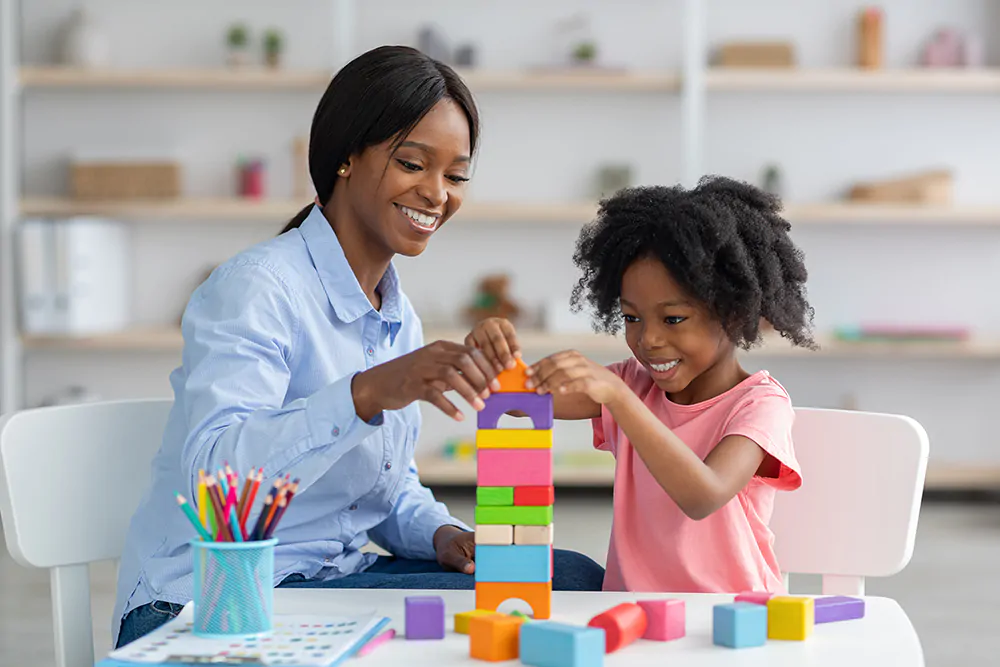 woman playing legos with girl
