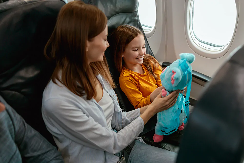 mother and daughter sitting in a plane