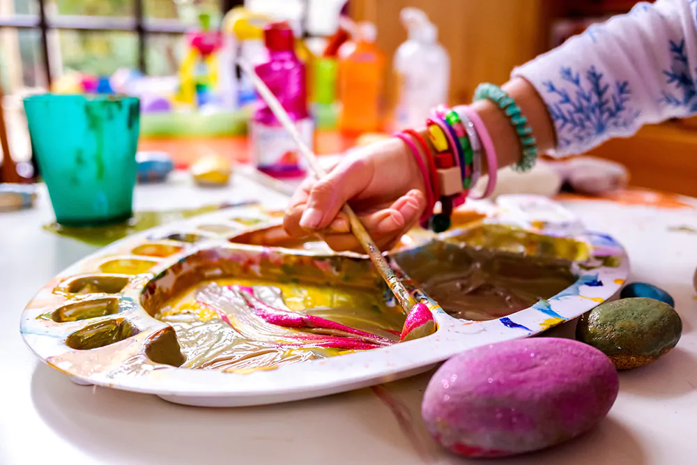 child painting rocks