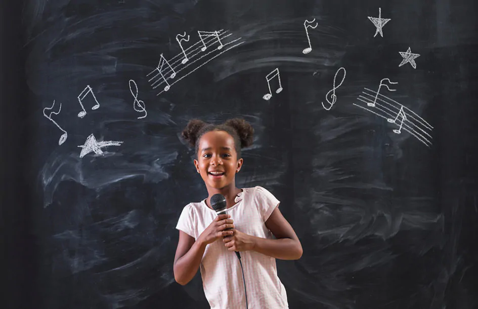 girl singing in front of a chalkboard