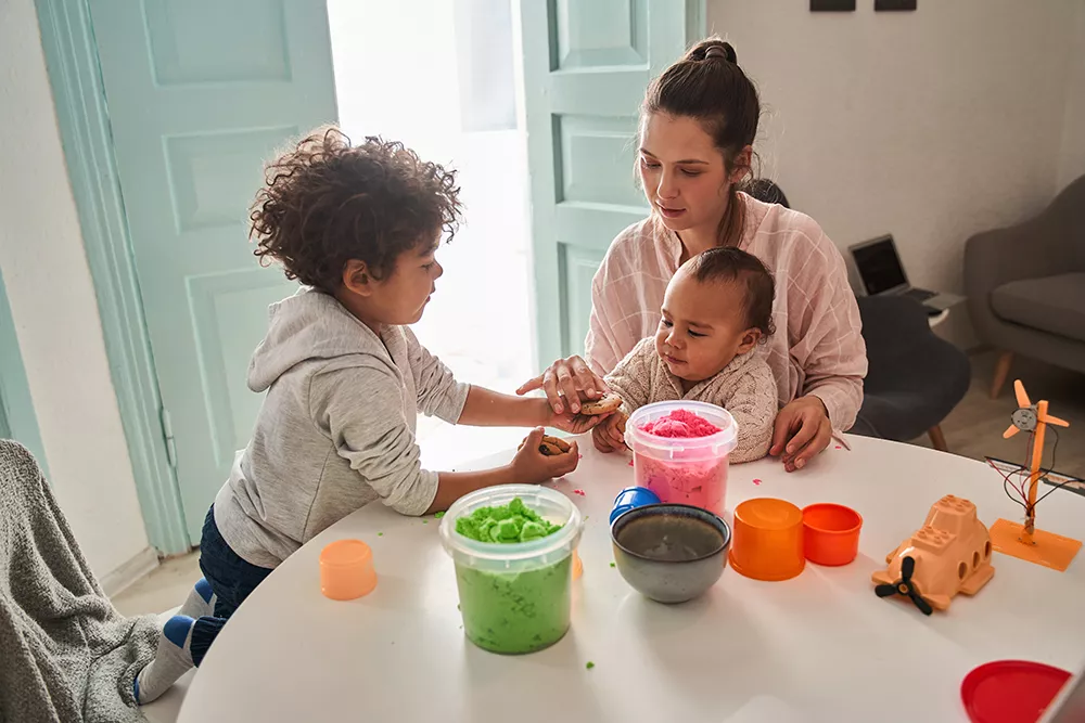 kids playing at the table with their mom