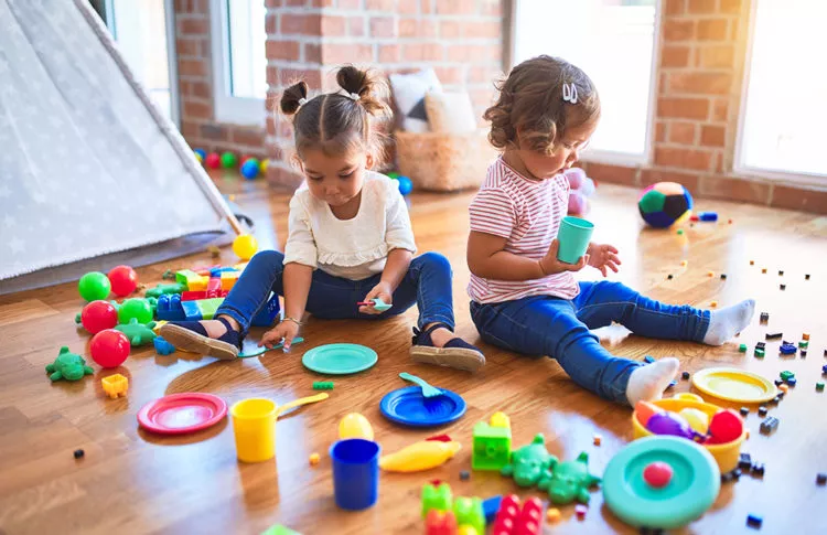 Adorable toddlers playing with colorful toys