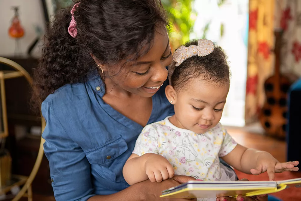 Mother reading to toddler daughter