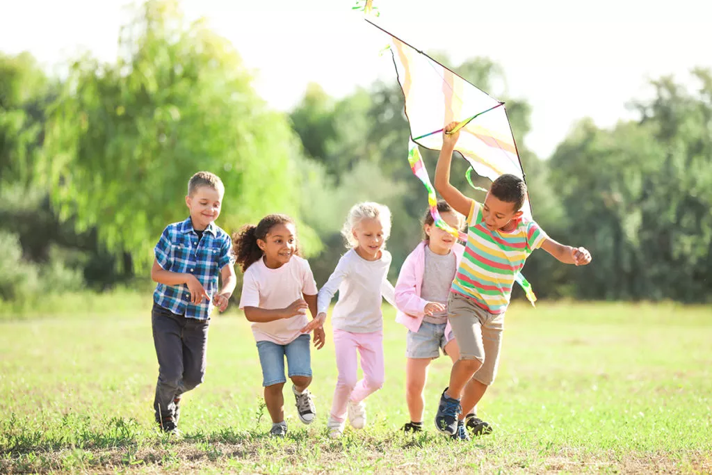Group of happy children with kite.