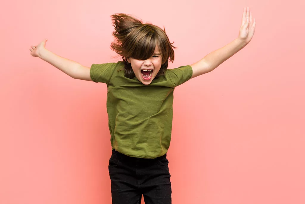little boy jumping up with excitement.