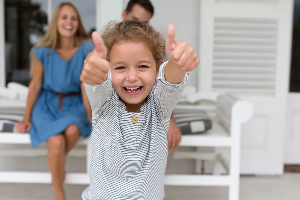 Portrait enthusiastic girl gesturing thumbs up