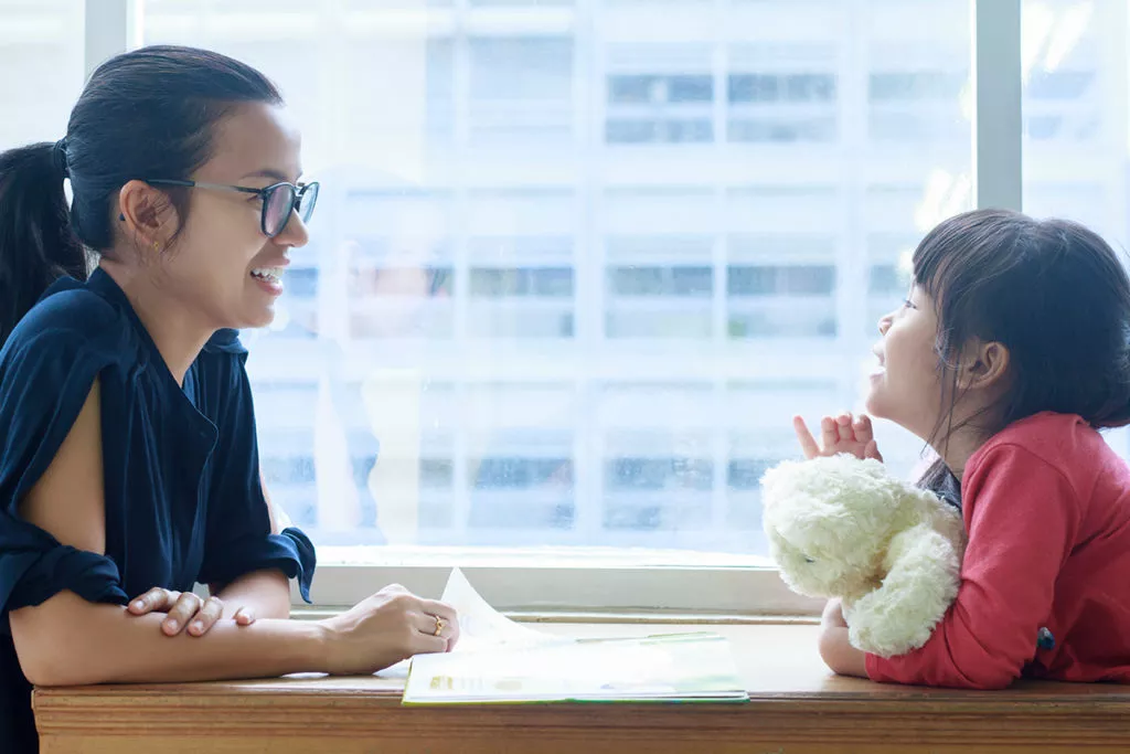 mother and daughter sitting and talking