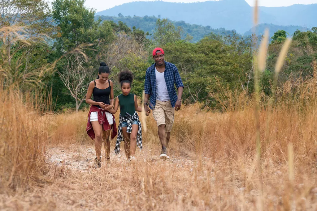 Mother, Father and daughter going on a nature hike in the summer in Maryland.