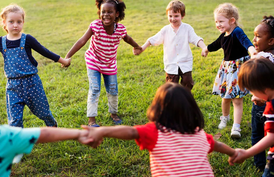 Silver Spring preschool kids having fun together holding hands in a big circle.