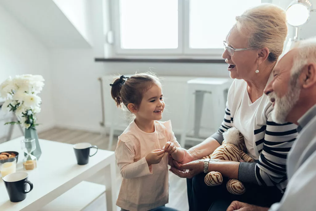 Young girl talking with her grandparents