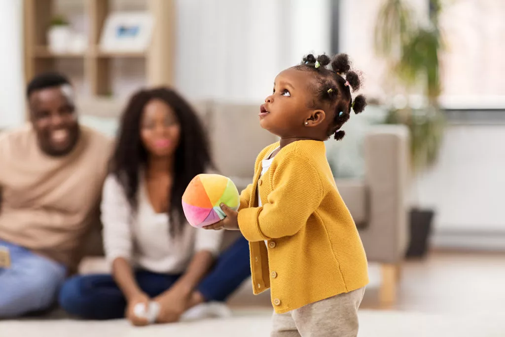 Parents watching their daughter playing at daycare to transition from home to child care in Potomac, MD