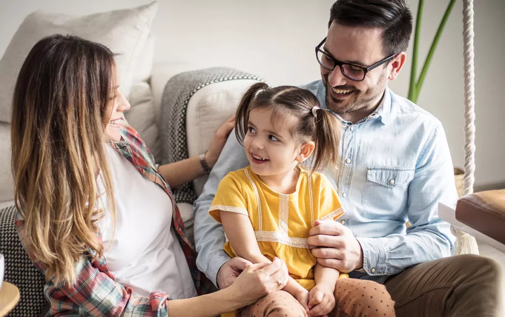 Parents talking to their daughter About What to Expect at a first day of Preschool.