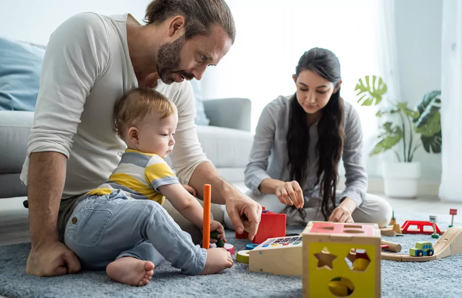 Parents with toddler playing and learning.