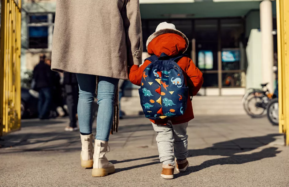 mother and child entering preschool for a smooth drop-off process.