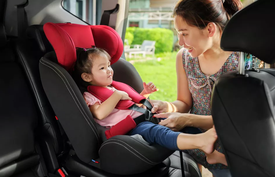 Mother Preparing her toddler for Daycare in the car on the way to a Rockville Day care Center.