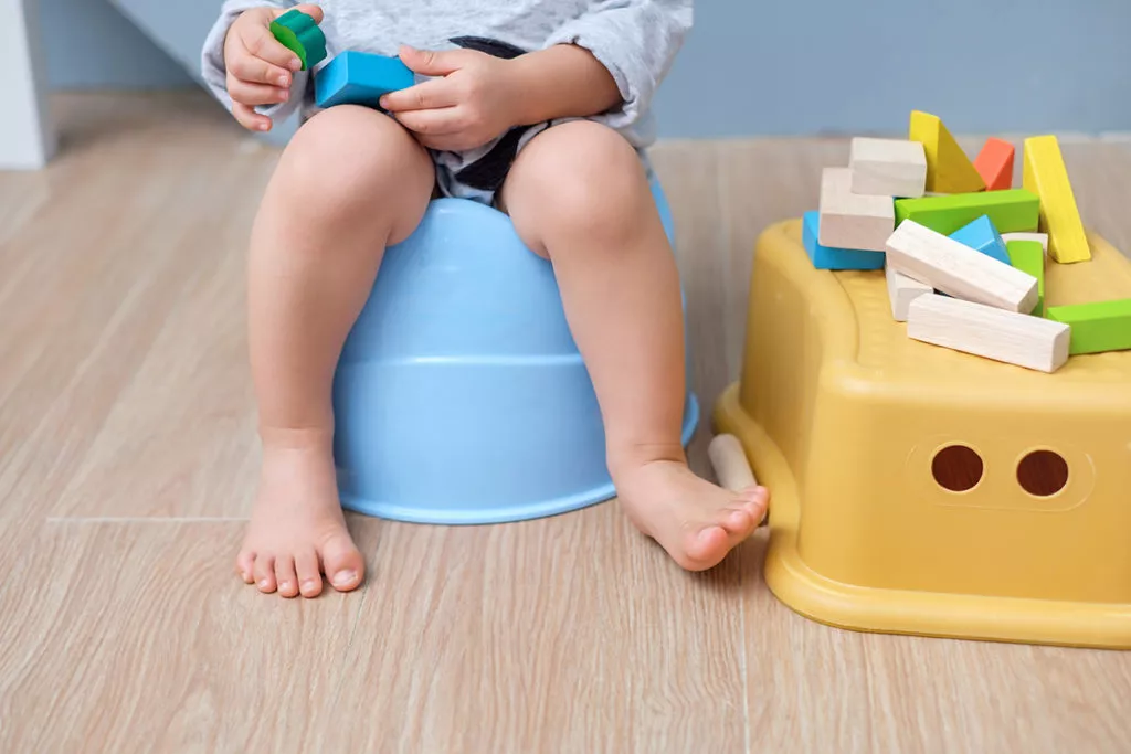 Toddler sitting on a training potty