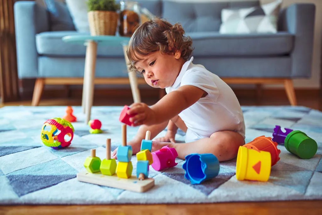Toddler playing with leaning toys in a Rockville, MD toddler daycare center.