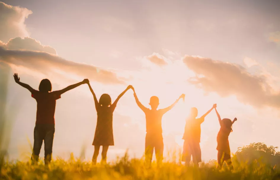 Silhouette of children holding hands demonstrating the importance of different learning styles in kids by a preschool in Potomac, MD