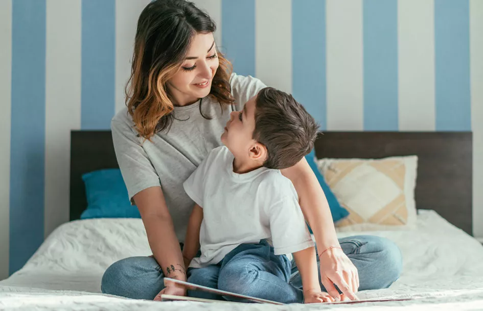 happy mother and cute toddler son looking at each other