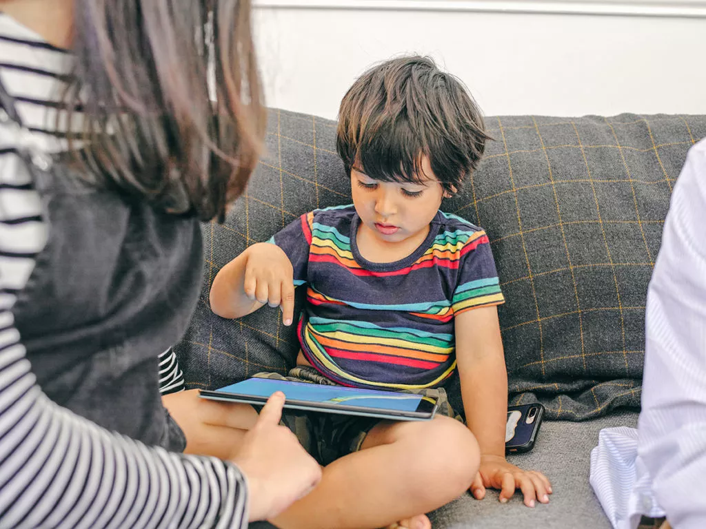 Boy using screen time as a learning activity as recommended by a Rockville Child care center.