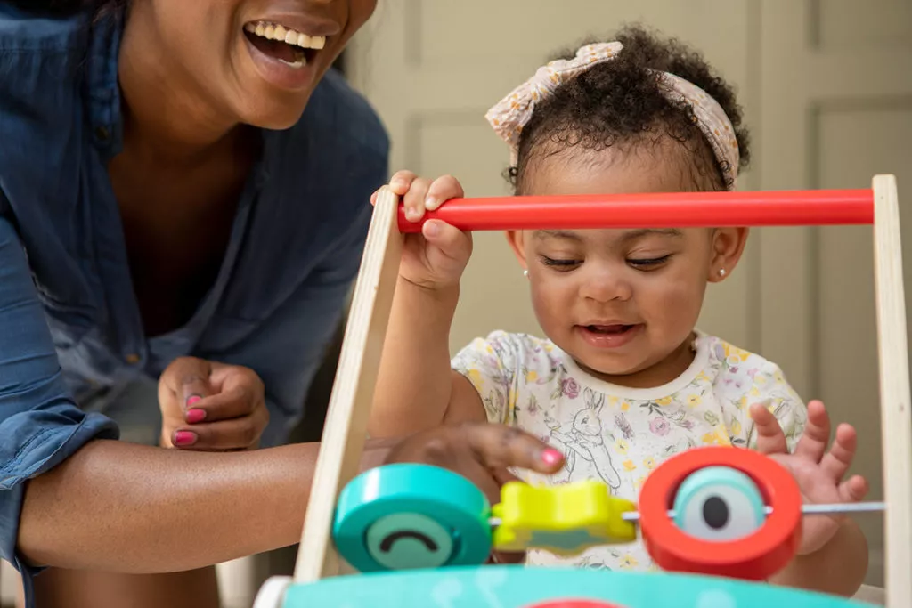Adorable toddler girl playing with learning toys at a Rockville, MD toddler daycare center.