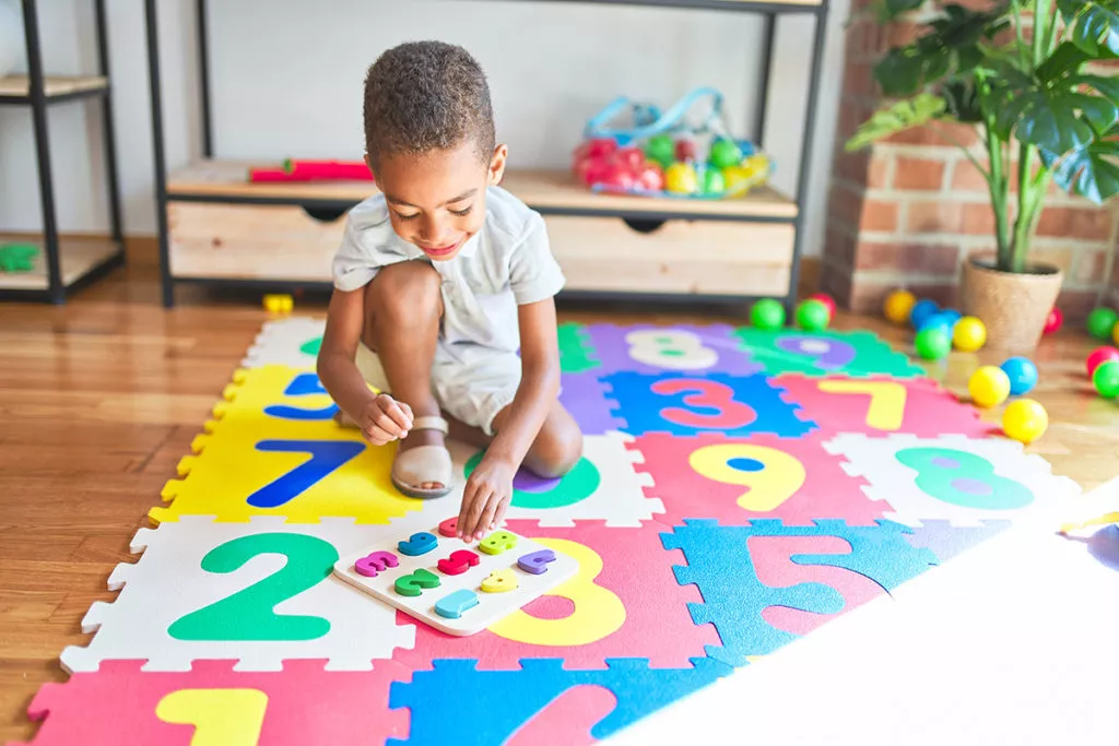 Boy playing with numbers and prepares for Kindergarden.