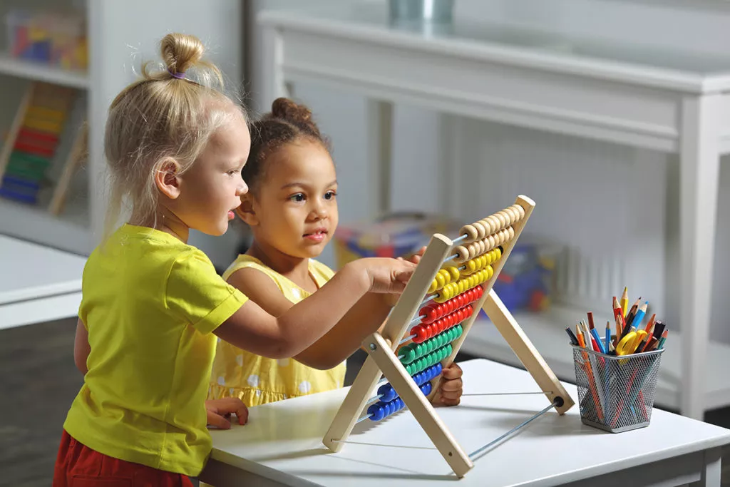 2 little girls preparing for Kindergarden while learning to count.