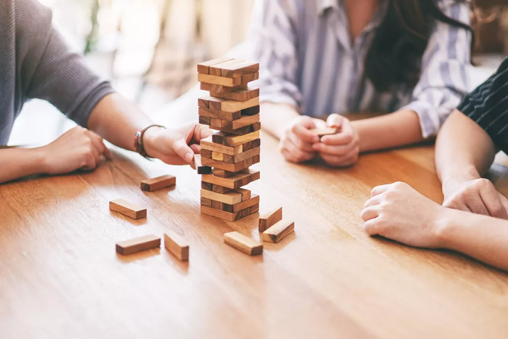 Closeup image of a family game night, playing Jenga during winter break.