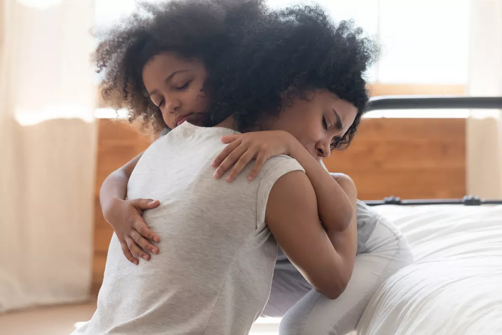 Daughter hugging her mother before they go to preschool in Silver Spring, MD.