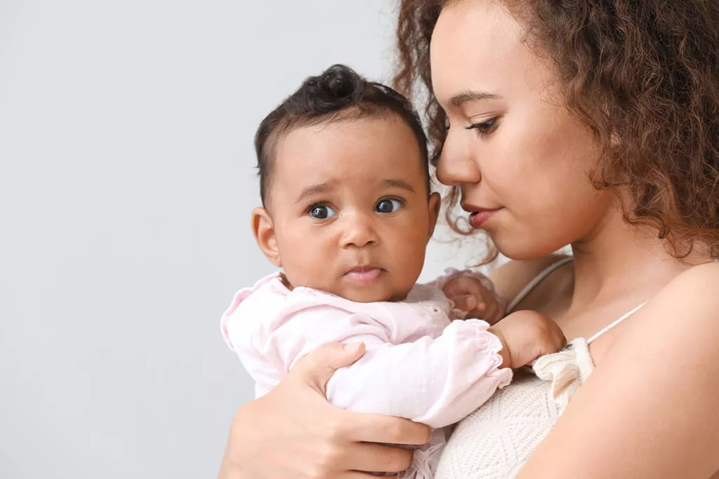 Mother holding her baby.