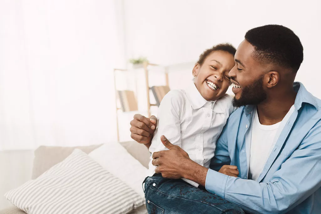 Father Tickling his child, Having Fun And Playing Together At Home