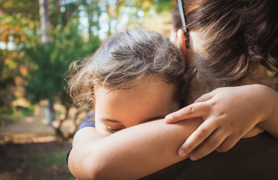 Close-up of daughter hugging her mother.