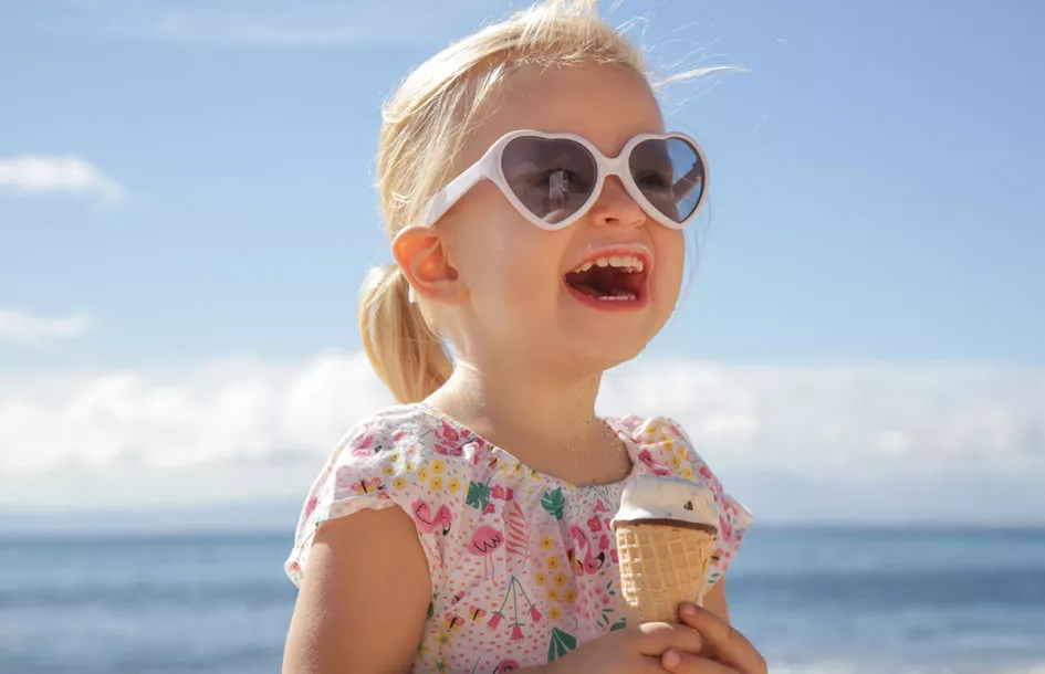 Little girl enjoying her ice cream cone on a summer day at summer camp in Rockville, MD