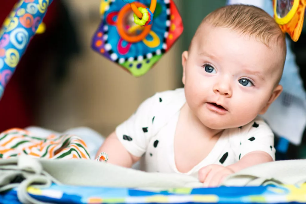 A closeup of an infant learning and building motor skills through fun activities like tummy time.