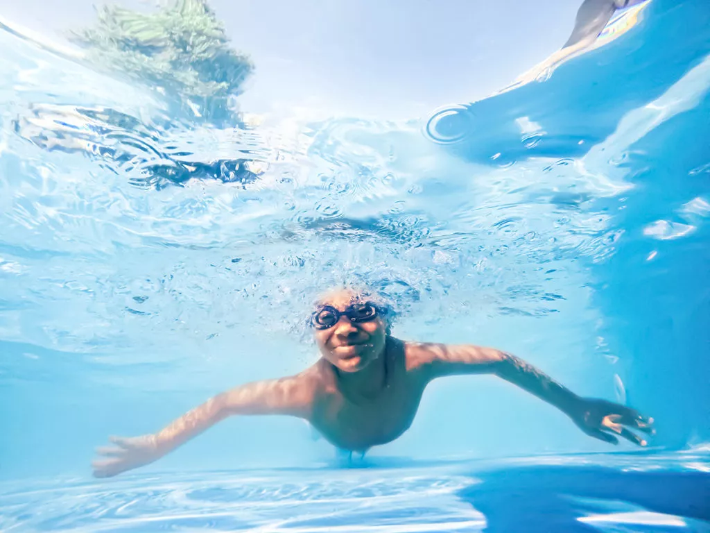 Underwater shot of a boy swimming in a pool enjoying the summer at his camp in Rockville, MD