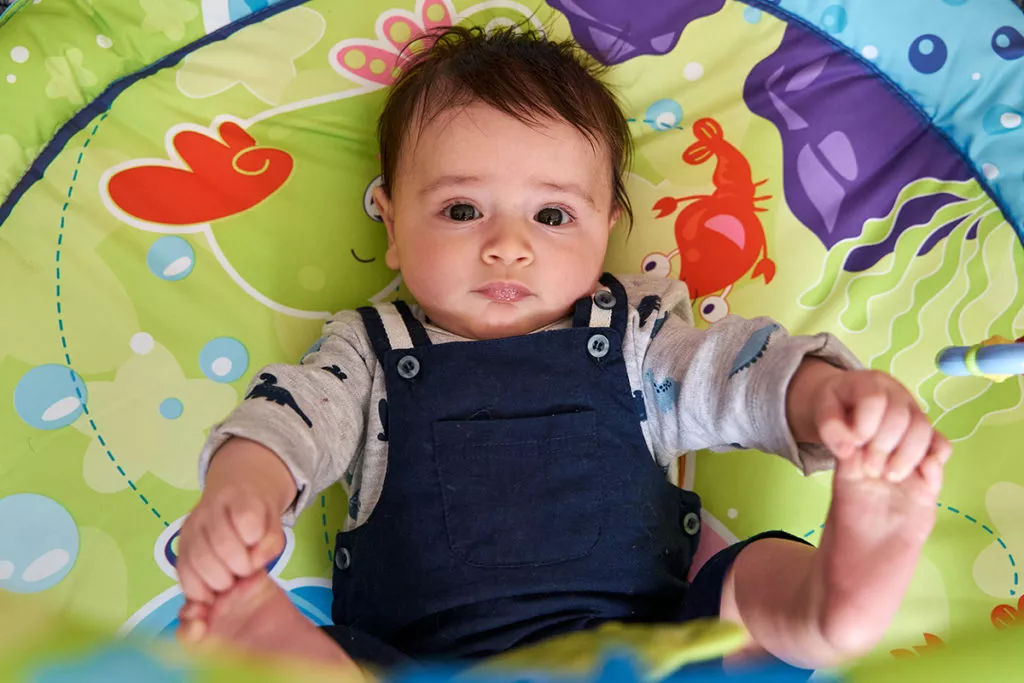 a baby enjoying playtime at an infant daycare in Rockville, MD.
