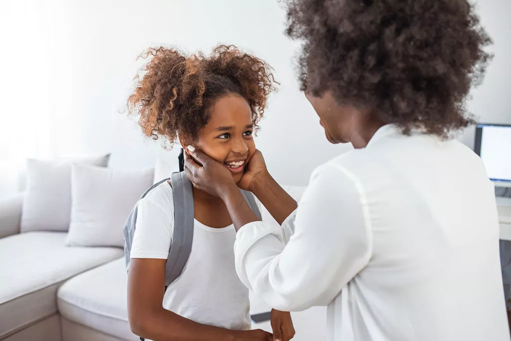 Young girl and her mother happy looking at each other after a day at an After-school program at a Rockville daycare.
