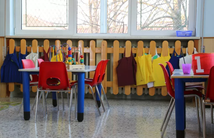 Questions to ask a child-care center in Maryland: classroom in kindergarten with red small chairs and tables