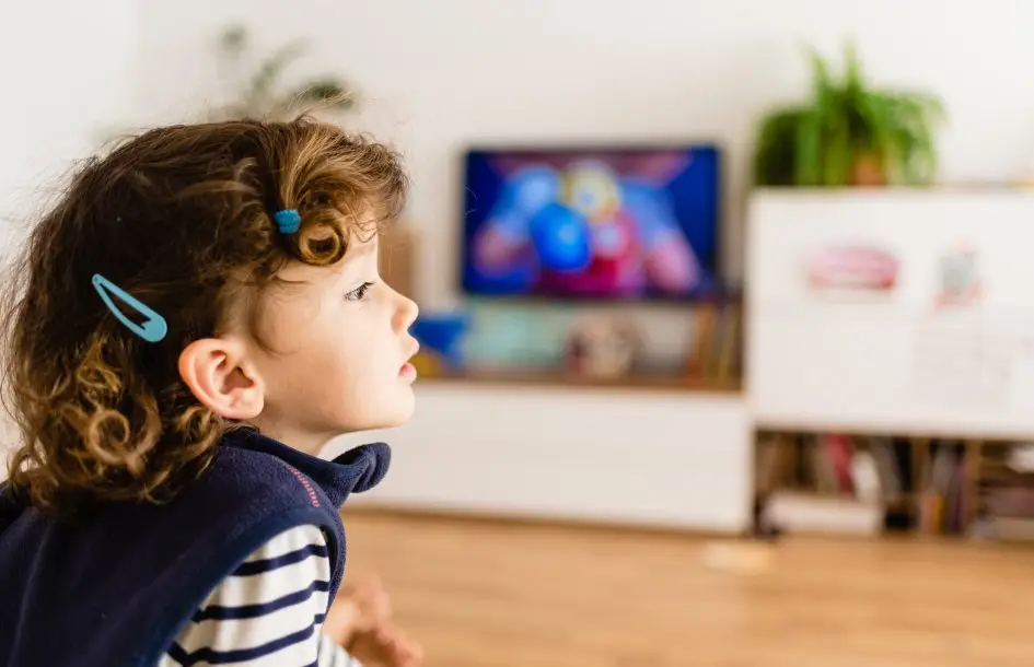 girl watching other kids play off screen