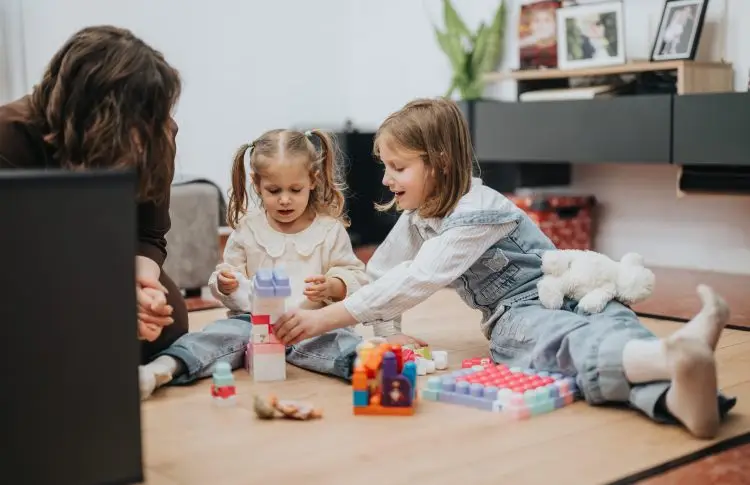 Family playing with colorful block toys together at home. why play is important for preschoolers