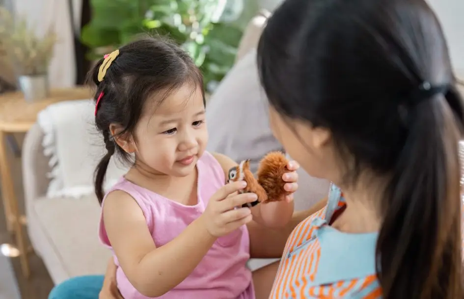 Mother and Daughter Bonding at Home with Toy to encourage back and forth conversation