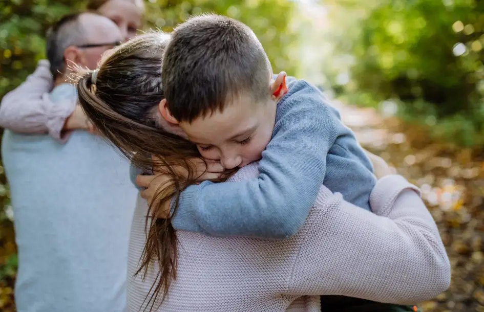 Little boy embracing his mother for preschool separation anxiety