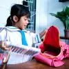 Building preschooler independent skills: independent young kindergarten student preparing her own stuff before going to school