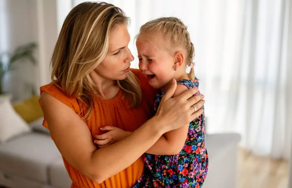 Mother comforting her crying little girl. Emotional regulation for preschoolers