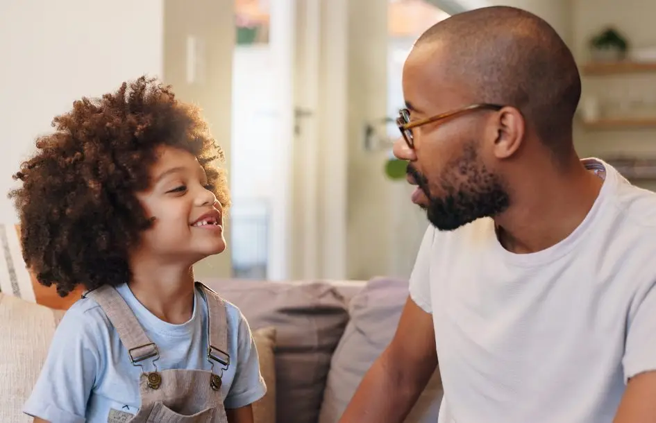 following directions-for preschoolers. Father, boy and couch in home, conversation or relax in living room for advice and bonding. Communication, support or love in lounge with dad
