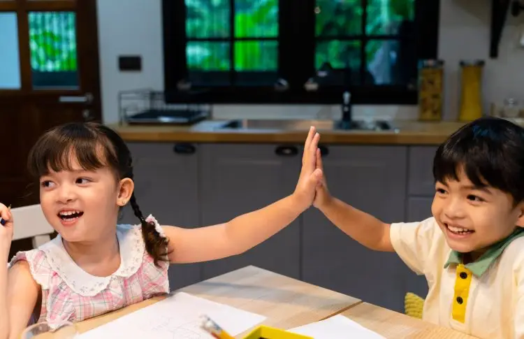 preschool friendships and why they matter, two preschoolers high five